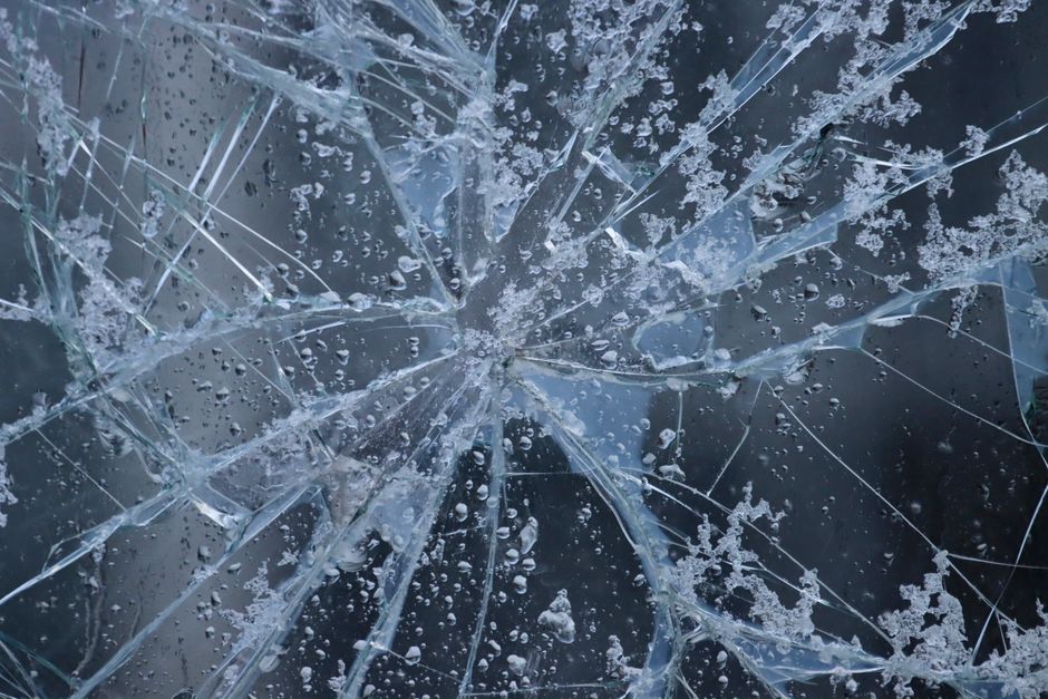 Cracked car windshield showing severe damage requiring full replacement