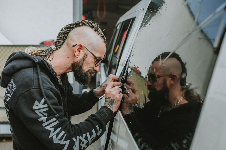 Technician performing an auto glass installation and chip repair process