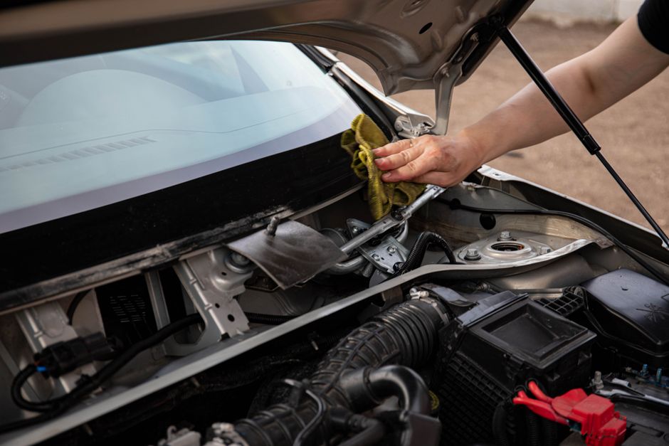 Professional technician performing windshield replacement on a modern vehicle